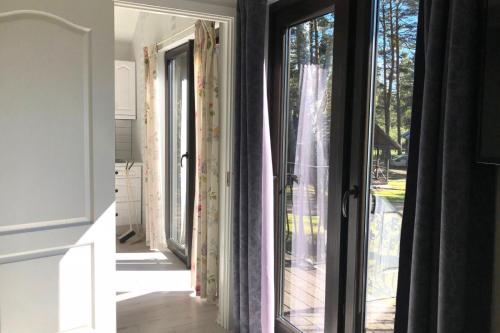 a room with a door open to a patio at Vērbeļnieki in Pērkone