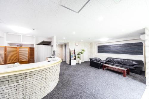 a living room with a bar and a couch at Best Hotel in Tokyo