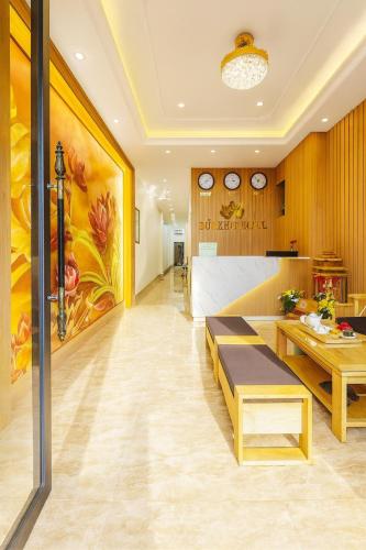 a living room with a large painting on the wall at Đức Khôi Hotel in Cao Bằng
