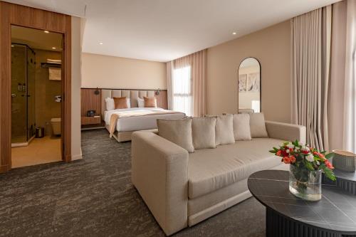 a hotel room with a couch and a bed at Citadines Almaz Aparthotel Casablanca in Casablanca