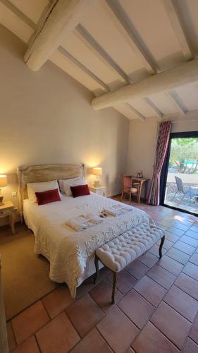 a bedroom with a large bed in a room at LE CLOS DES CYPRES - Maison d'hôtes de Charme - Diner Gourmet & Bien-être in Graveson