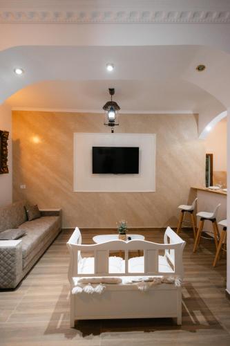 a living room with a couch and a tv at Marcos Apartments I Bathtub in Bedroom experience in Făgăraş