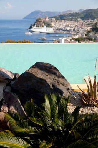 a view of the ocean with a rock and plants at Hotel Villa Enrica - Aeolian Charme in Lipari