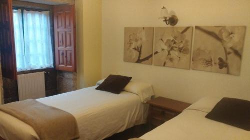 En eller flere senge i et værelse på hotel La rectoral