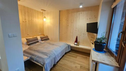 a bedroom with a bed and a tv in it at Willa Mitia in Zakopane