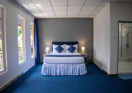 En eller flere senge i et værelse på Wecay Holidays