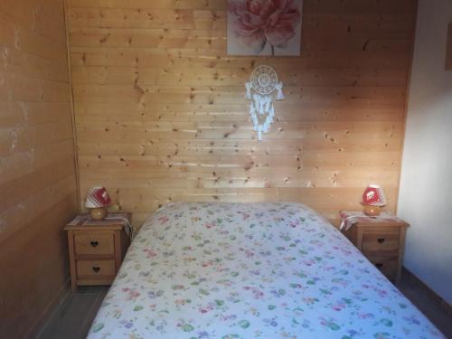 a bedroom with a bed and two night stands at Chalet pour 2 personnes à 700m du Centre Ville in Gérardmer