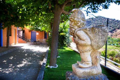 a stone statue of a boy playing a guitar at Suite Rural Carenas in Carenas