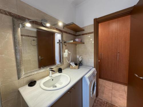 ein Badezimmer mit Waschbecken und Spiegel in der Unterkunft Jassemi Studio in Mavrovouni