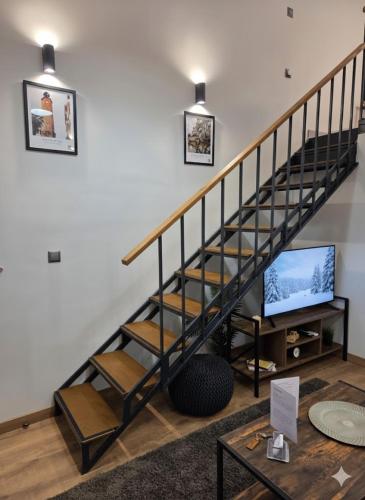 sala de estar con escalera y TV en Homey Edessa Loft, en Édessa