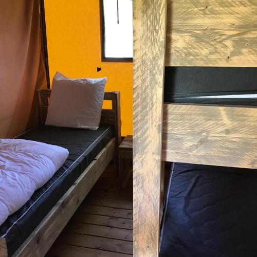 a room with a bunk bed and a pillow at Camping Le Mondou in Saint-Julien-de-Lampon