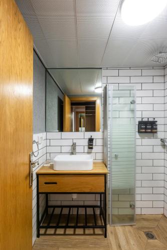 a bathroom with a sink and a glass shower at Roxon Desert Arad in Arad
