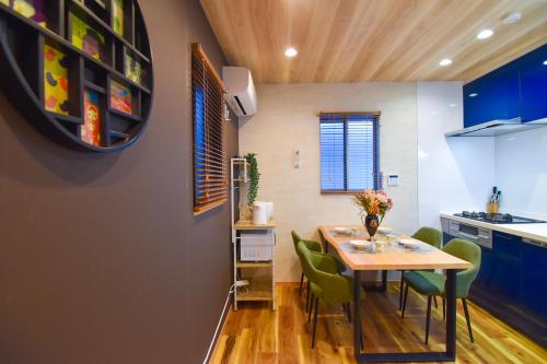 a kitchen and dining room with a table and chairs at MARIO House - Free Parking- in Osaka
