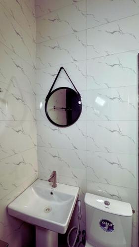 a bathroom with a sink and a mirror on the wall at Rachel's Place in Ibadan