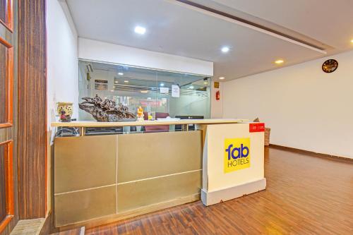 a fast food restaurant with a counter in a room at FabHotel The Walnut in Pune