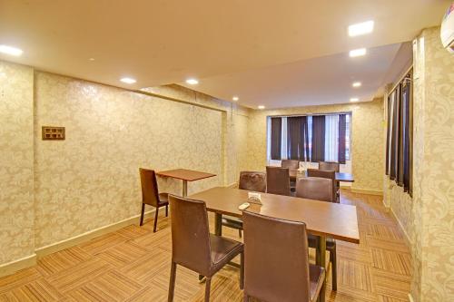 a conference room with wooden tables and chairs at FabHotel The Walnut in Pune