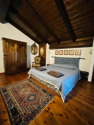a bedroom with a large bed and a rug at Agriturismo Ca' di Mazza in Monzuno