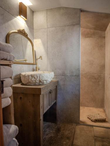 a bathroom with a sink and a shower at Chalet with fireplace and sauna in Meiringen