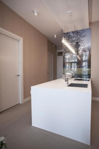a kitchen with a white counter in a room at Maurits Apartments & Suites in Rotterdam