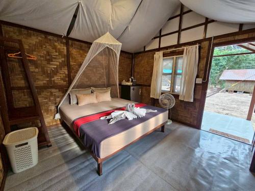 a bedroom with a bed in a tent at Phayam Local homestay in Ko Phayam