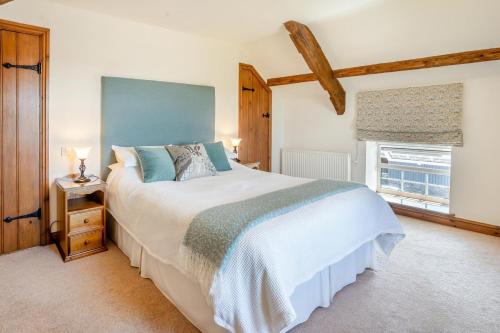 a bedroom with a large bed and a window at 1 Bed in Nantygwreiddyn oc-bow49 in Sennybridge