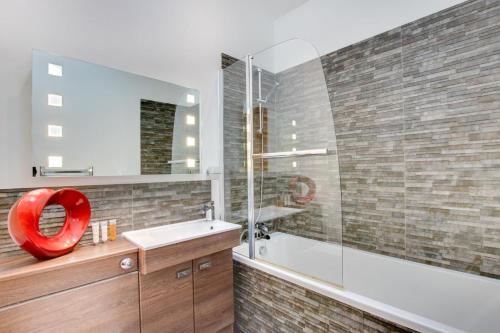 un bagno con un lavandino, una vasca e uno specchio di 2 Bed in Bala oc-82212 a Bala