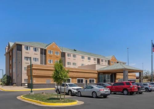 a parking lot with cars parked in front of a building at Quality Inn & Suites Denver Airport - Gateway Park in Aurora