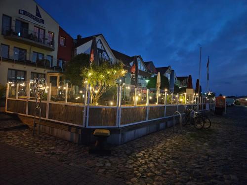 a fence with lights in front of a building at Pension Hafenblick in Barth