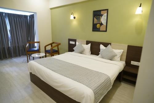 En eller flere senge i et værelse på Hotel Regalia