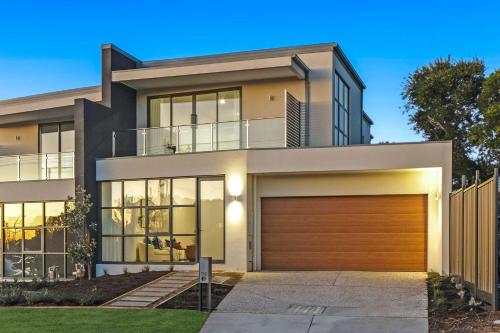 a modern house with a garage at Poolside Luxury Villa - Solar Pool Beach 3min in Mornington
