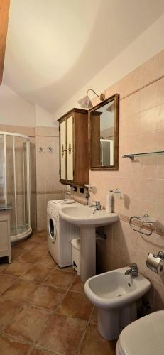 a bathroom with a sink and a toilet and a mirror at Casa del Comandante- Bluchalet in Cervo