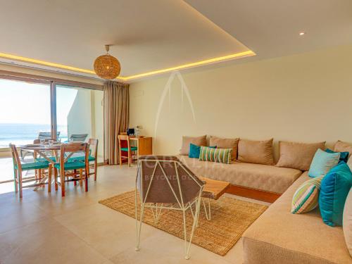 a living room with a couch and a table at Illy - Ocean by Coralia - 4 Px in Taghazout