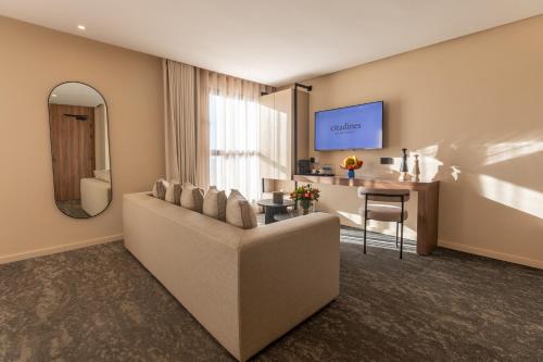 a living room with a couch and a table at Citadines Almaz Aparthotel Casablanca in Casablanca