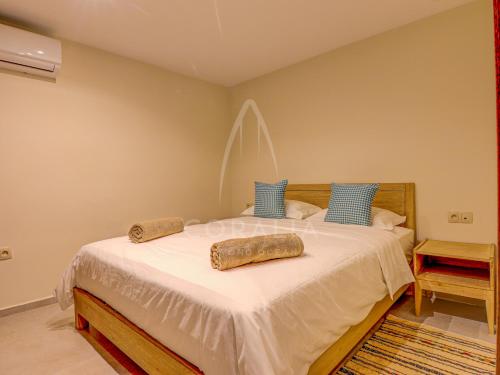 a bedroom with a bed with two pillows on it at Illy - Ocean by Coralia - 4 Px in Taghazout