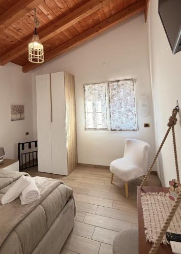 a bedroom with a bed and a chair at B&B LA VILLA Rozzano - HUMANITAS - FORUM ASSAGO - MILANO FIORI - IEO - MILAN DESIGN WEEK 2026 in Rozzano