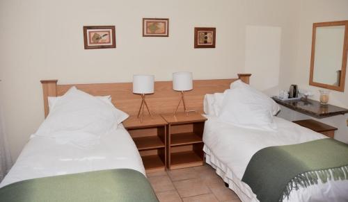 duas camas uma ao lado da outra em um quarto em Siesta B&B em Vryheid