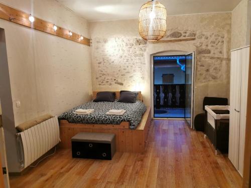 a small bedroom with a bed in the middle of a room at Annecy Carnot in Annecy