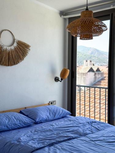 a bedroom with a bed and a window with a view at aden suits teras in Fethiye