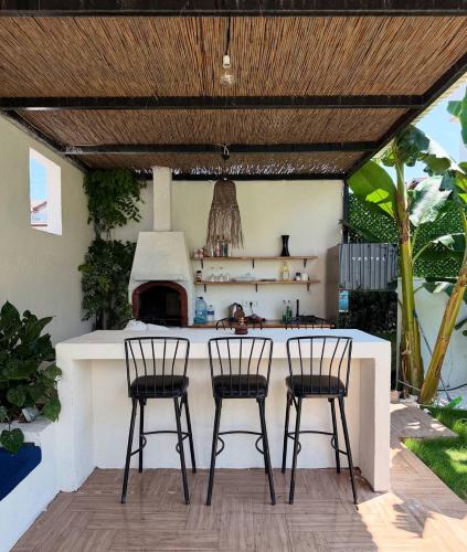 an outdoor kitchen with two chairs and a stove at aden suits teras in Fethiye