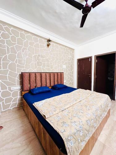 a bedroom with a bed with blue pillows at Emerald Villa by Crystal Villas in Jāmb