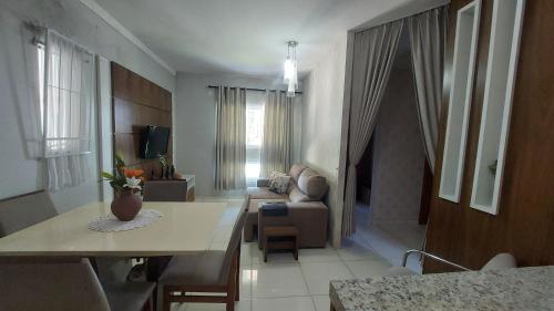 a living room with a couch and a table at Casa Alegre Beach House in Penha
