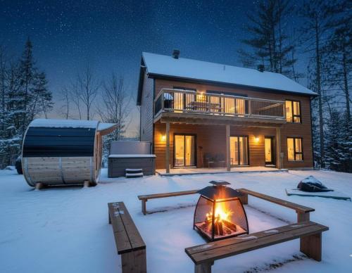 een huis in de sneeuw 's nachts met een tent bij Foosball table Spa & Sauna - Sommetoile in Saint Come