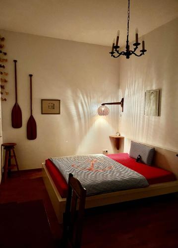 a bedroom with a bed and a chandelier at 2-Zimmer-Apartment "Monbijou" am Hackeschen Markt in Berlin