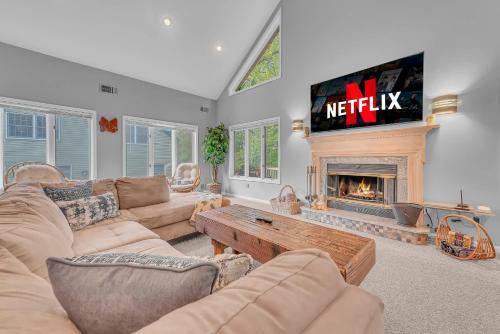 a living room with a tv and a fireplace at Large Family Friendly House on the Fairway Hideout in Lakeville