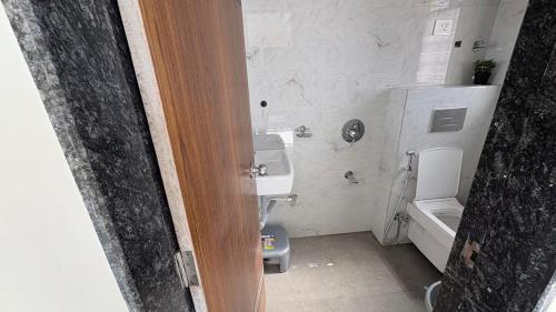 a small bathroom with a toilet and a sink at Friendz Villa in Igatpuri