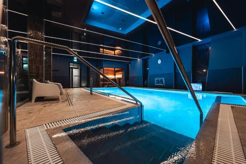 a large swimming pool in a building at Arensburg Boutique Hotel & Spa in Kuressaare