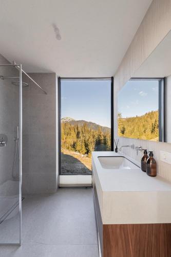 a bathroom with a sink and a large window at Mountain air Legit in Palyanytsya