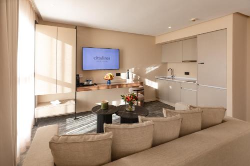 a living room with a couch and a table and a kitchen at Citadines Almaz Aparthotel Casablanca in Casablanca