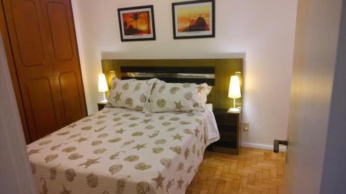 a bedroom with a large bed and two lamps at Copacabana Amazing Copacabana in Rio de Janeiro