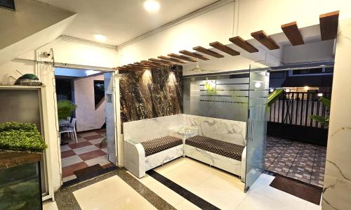 a room with a bench in the middle of a building at Basil Inn in Pune
